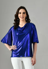 Women’s metallic lycra midnight blue party wear top with draped neckline and relaxed fit sleeves styled with white pants