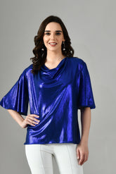 Women’s metallic lycra midnight blue party wear top with draped neckline and relaxed fit sleeves styled with white pants. beach top for women,summer tops,summer tops for women, designer top in gurgaon, party wear tops, isara Tops