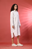Casual white shirt dress with long sleeves, ideal for summer outings.