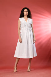 White sleeveless linen dress for women, offering a flattering fit for a chic summer look.