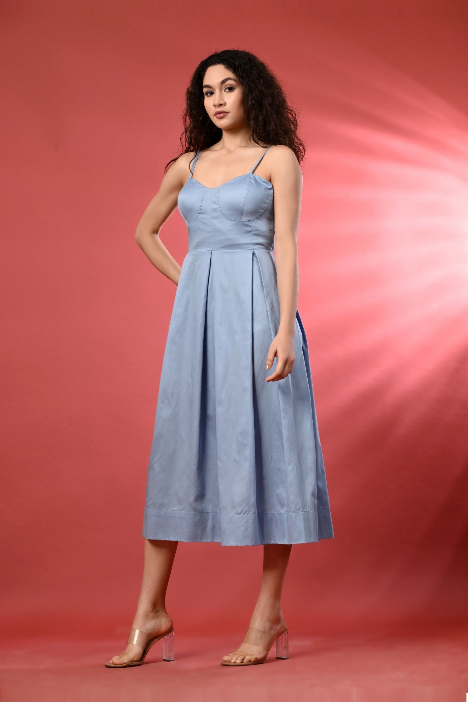 Sky blue long linen dress with a cold shoulder design, flowing silhouette, and soft pastel tone. Styled in a breezy outdoor 