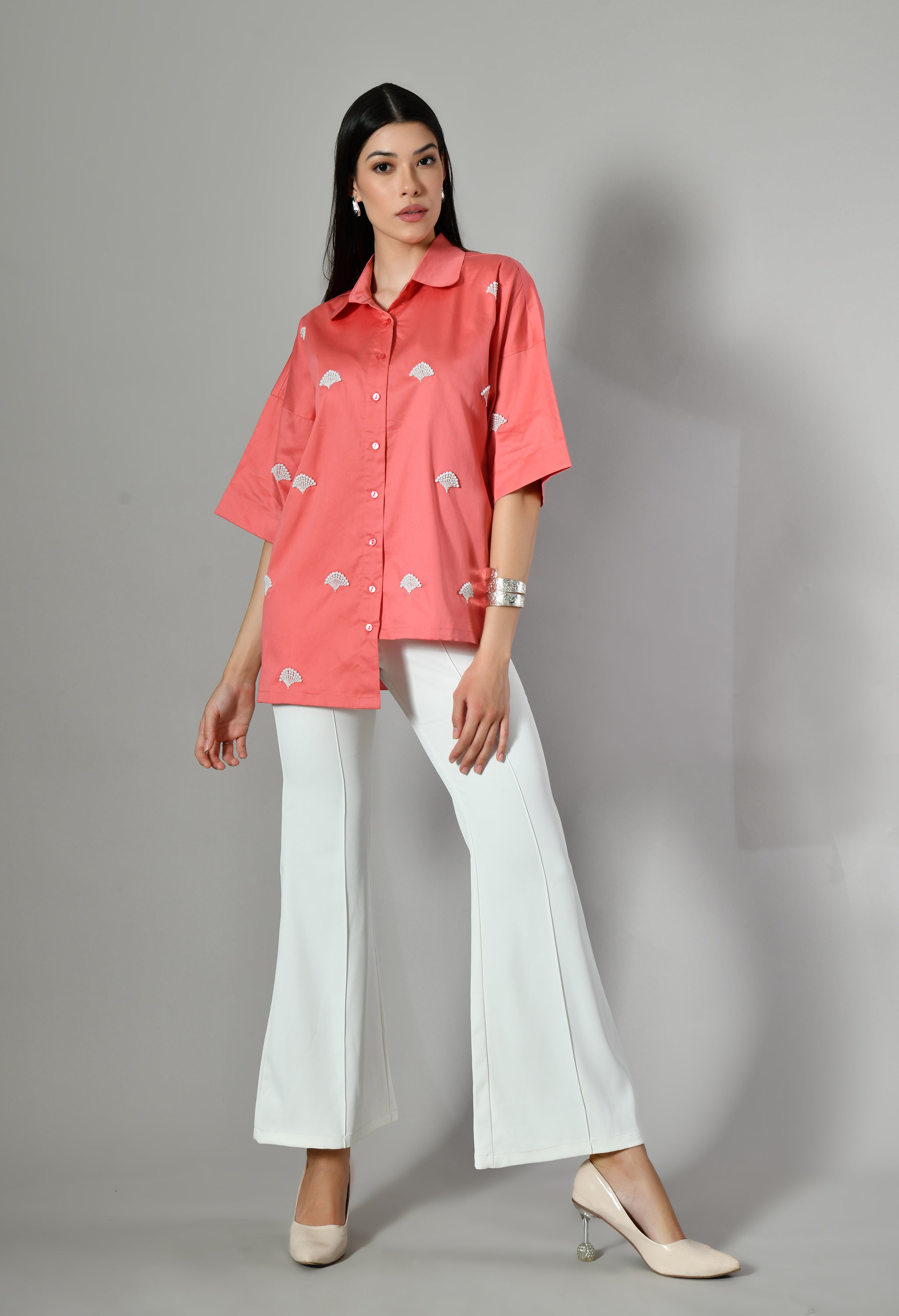 Isara's fusion coral cotton shirt for women – a casual yet formal-ready oversized shirt perfectly matching with white pants.