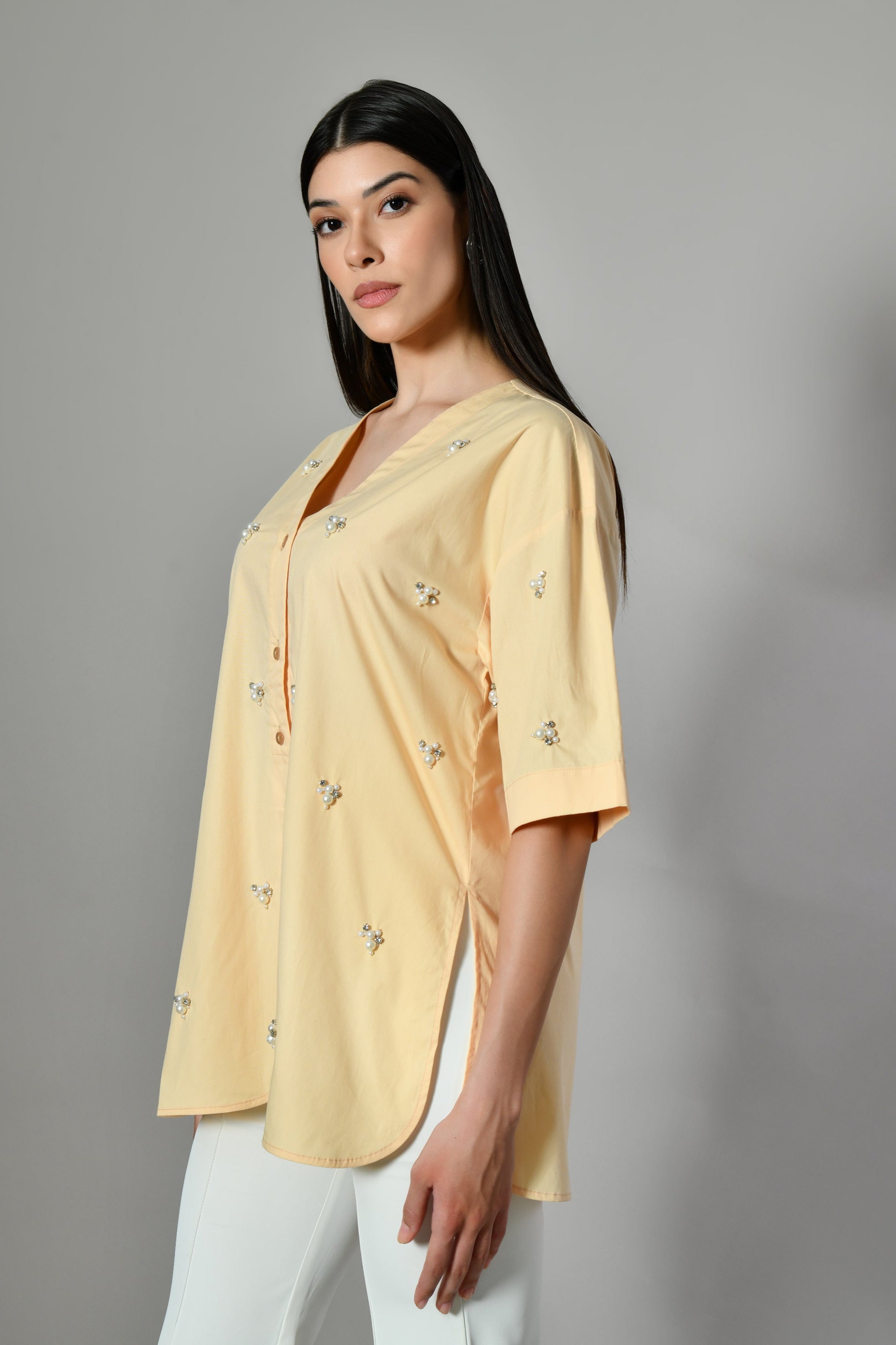 Stylish Yellow V-neck shirt – breathable cotton with elegant pearl detailing. Women’s pastel shirts, Shirts for working women.
